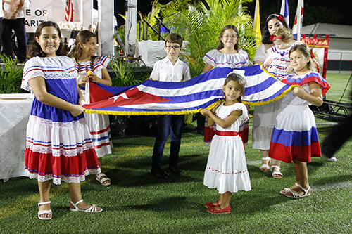 Young children with Cuban roots carried the Cuban flag during the Mass in honor of Our Lady of Charity Sept. 7, 2024, at Milander Park in Hialeah.