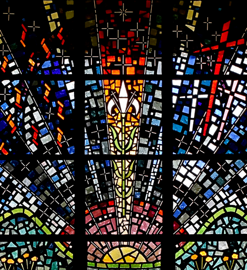 A lily, symbolic of purity, dominates a window at St. Bernard Church in Sunrise. Also visible are the crosses of Calvary.