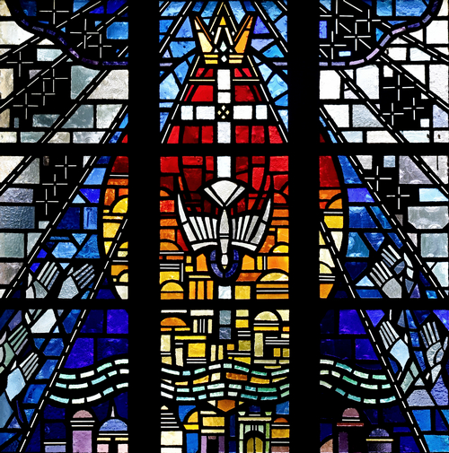 God - symbolized as a crown for the Father, a cross for the Son, and a dove for the Holy Spirit - bring the New Jerusalem to Earth in this window at St. Bernard Church in Sunrise.