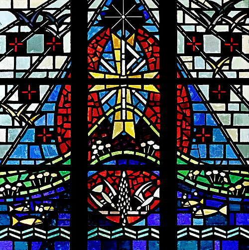 A double symbol of Christ - a cross and a Chi-Rho - form the centerpiece of this window at St. Bernard Church in Sunrise. Chi and Rho are the first two letters of Christos, Greek for Christ. The cross is in gold for the presence of God and the Resurrection of Jesus.