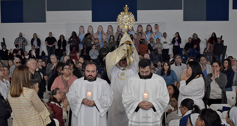 Deacon Ismar Martinez carries the Blessed Sacrament during the annual archdiocesan Catechetical Conference at Epiphany Church and Our Lady of Lourdes Academy in Miami, Oct. 19, 2024.