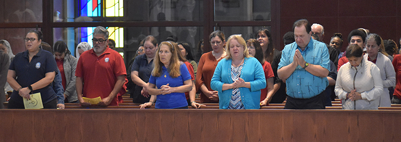 Catholic school teachers and parish religious educators pray during Mass at the annual archdiocesan Catechetical Conference at Epiphany Church and Our Lady of Lourdes Academy in Miami, Oct. 19, 2024.