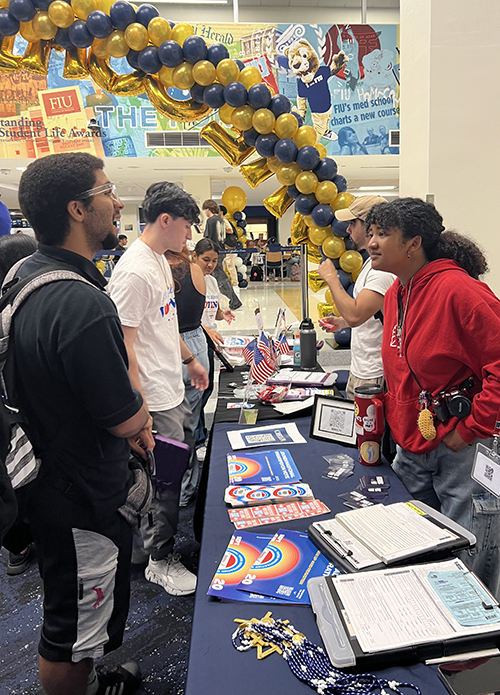 Daliannette Garcia-Pagan, a member of the Catholic campus ministry at Florida International University, helps a student register to vote Sept. 17, 2024, the National Voter Registration Day, at the FIU Graham Center in Miami.