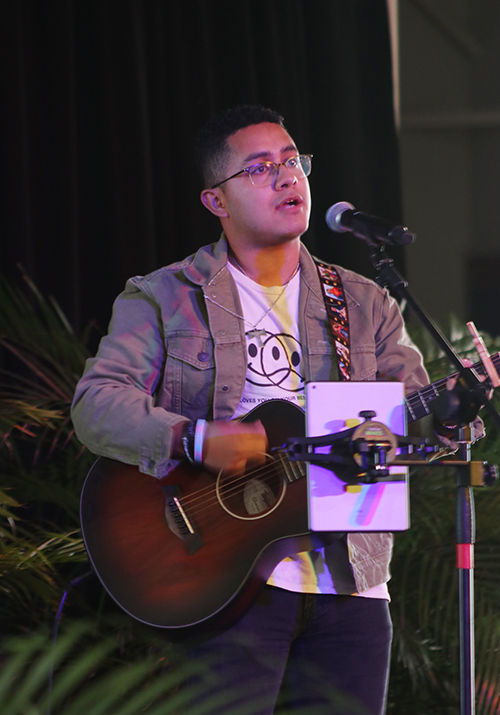 Julio Soriano, a theology teacher and assistant director of campus ministry at Immaculata-La Salle High School in Miami, sings praises to the Lord at the start of the Pro-life Rally Sept.27, 2027, at St Thomas University in Miami Gardens.