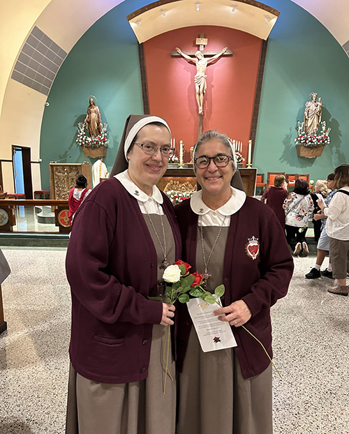 Sister Karla Icaza, left, and Sister Maria Jose Socias of the Servants of the Pierced Hearts of Jesus and Mary enjoyed the uplifting centennial Mass of Little Flower Parish in Hollywood celebrated by Archbishop Thomas Wenski Oct. 1, 2024. The two sisters serve in the parish school, which is also celebrating its 75th anniversary.