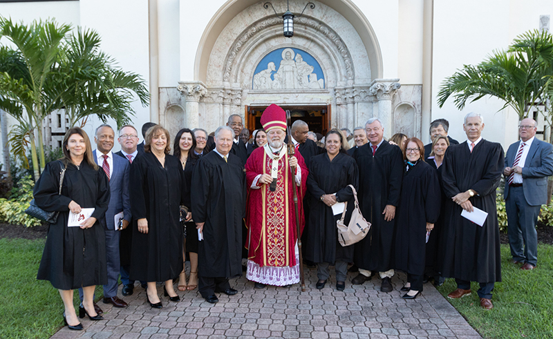 Miami Archbishop Thomas Wenski, who celebrated the annual Red Mass for Broward County Oct. 2, 2024, at St. Anthony Parish in Fort Lauderdale, poses for a group photo with regional lawyers, judges, public officials and other law professionals following the Mass.