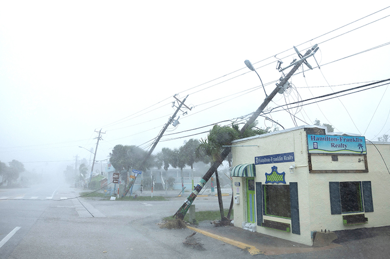 Broken utility poles downed by strong wind gusts are seen as Hurricane Milton approaches Fort Myers, Fla., Oct. 9, 2024. As Hurricane Milton bears down on Florida just days after Hurricane Helene.