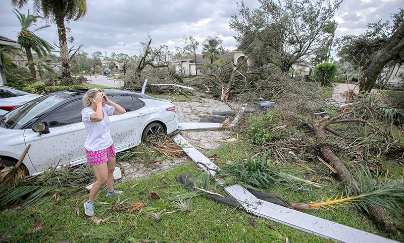 Marie Cook reacts to the damage to her home in Wellington, located within the Diocese of Palm Beach, Oct. 10, 2024, after a tornado formed by Hurricane Milton touched down striking homes in the neighborhood and surrounding area on Florida’s Gold Coast.