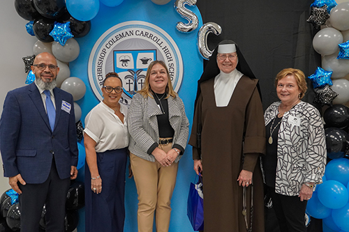 From left, Archbishop Coleman Carroll High School Board President Daniel Elie; Miami Dade representatives Maite Padron and Pamela David; Sister Margaret Ann Laechelin, principal of the school; and Toni Pallato, marketing consultant, Eagles Wings Communications, pose for a picture after the St. Michael's Scholars Program induction ceremony Oct. 24, 2024, in the school's gymnasium.