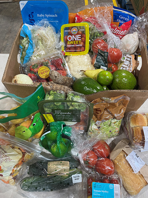 Vegetables and other produce are among the items that are packed and distributed at Catholic Charities Matthew 25 Food Pantry in Miami shows a variety of food items. Over 1,500 households receive boxes like this one on the first and third Saturdays of the month, and weekly if needed.