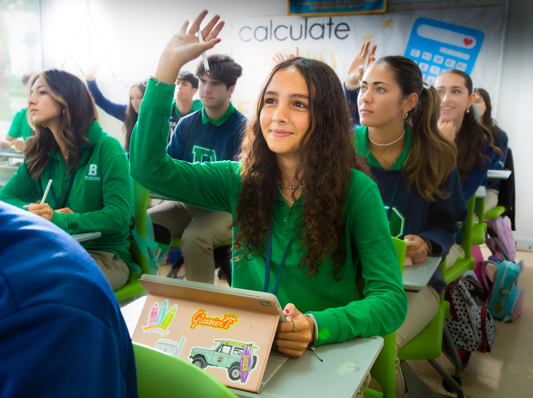 Using their iPads in class, students from St. Brendan High School raise their hands to answer questions during a lesson. St. Brendan High was named an Apple Distinguished School in August 2024 for their innovation, leadership and educational excellence. They join five other Archdiocese of Miami Catholic Schools that hold the distinction.