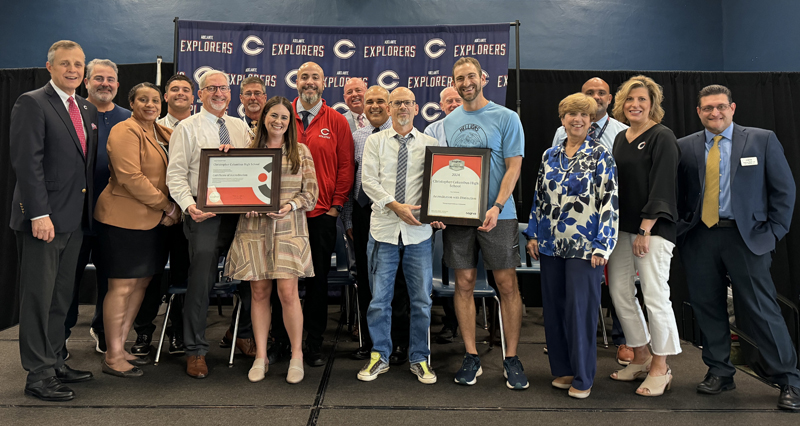 On October 16, 2024, Cognia representatives recognize Christopher Columbus High as a Cognia School of Distinction. Pictured (left to right) are Columbus High President Thomas Kruczek, Cognia's Senior Director Dianna Weinbaum, Cognia's Senior Director of the U.S. Southeast Andy Martinez, and members of Columbus' administrative and accreditation leadership team.