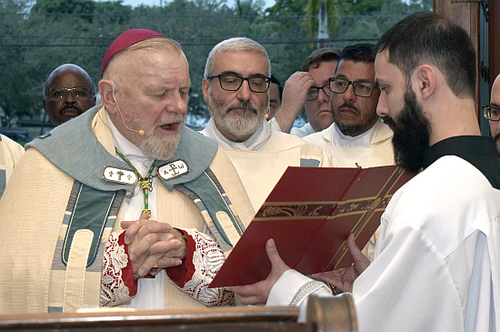 Archbishop Thomas Wenski reads the papal proclamation for the Jubilee Year at the start of the special Mass Dec. 28, 2024, at St. Mary Cathedral in Miami.