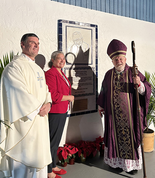 Archbishop Thomas Wenski, right, blessed a plaque dedicated to Father Mario Vizcaino. With him are Father Rafael Capó, vice president of Mission at St. Thomas University in Miami Gardens and former director of SEPI, and Olga Villar, director of SEPI.