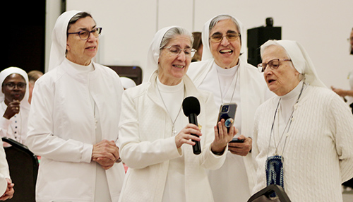 The Sisters of St. Joseph Benedict Cottolengo sing “Tu scendi dalle stelle,” an Italian Christmas song, during the Serra Club of Miami’s Christmas Dinner for Religious on Sunday, Dec. 8, 2024, at St. John Vianney College Seminary. The annual event, hosted by the Serra Club lay organization for vocations, celebrates local religious from around South Florida.