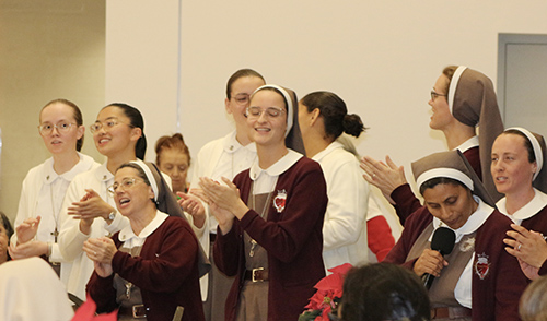 The Servants of the Pierced Hearts of Jesus and Mary sing “La Guadalupana,” a Mexican song for the feast of Our Lady of Guadalupe, during the Serra Club of Miami’s Christmas Dinner for Religious on Sunday, Dec. 8, 2024, at St. John Vianney College Seminary. The annual event, hosted by the Serra Club lay organization for vocations, celebrates local religious from around South Florida.