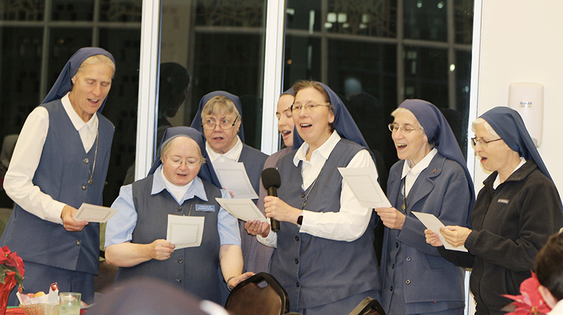 The Daughters of St. Paul sing “Bambino Divino,” an Italian Christmas song, during the Serra Club of Miami’s Christmas Dinner for Religious on Sunday, Dec. 8, 2024, at St. John Vianney College Seminary. The annual event, hosted by the Serra Club lay organization for vocations, celebrates local religious from around South Florida.