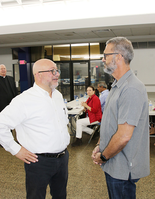 Hussam Musleh, left, speaks with Peter Portu, a parishioner of the Church of the Little Flower in Coral Gables, at the event entitled "Pray for the Peace of Jerusalem" on Dec. 10, 2024, at St. Gregory the Great Church in Plantation.