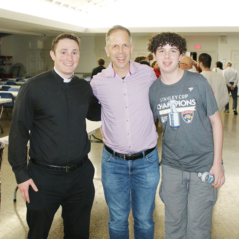 (Left-Right) Father John Buonocore, parochial vicar at St. Gregory the Great Church in Plantation, poses with parishioners Jim Januszka and his son Joey. They attended the evening to “Pray for the Peace of Jerusalem" on Dec. 10, 2024, at St. Gregory.