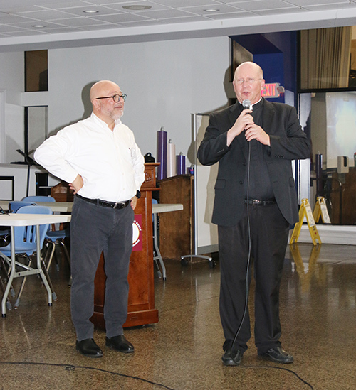 Father Michael Davis, pastor of St. Gregory the Great Church in Plantation, introduces Hussam Musleh of Israel, who spoke about the dwindling Christian population in Israel and Palestine at the "Pray for the Peace of Jerusalem" event on Dec. 10, 2024, at St. Gregory.