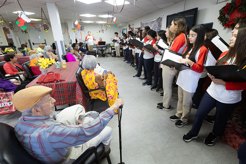 Students from Cardinal Gibbons High School in Fort Lauderdale sang Christmas carols and holiday music Dec. 11, 2024, for the elderly and their family and friends at Wilton Manors Adult Day Care Center/Catholic Charities of the Archdiocese of Miami.