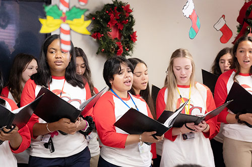 Students from Cardinal Gibbons High School in Fort Lauderdale sang Christmas carols and holiday music Dec. 11, 2024, for the elderly and their family and friends at Wilton Manors Adult Day Care Center/Catholic Charities of the Archdiocese of Miami.