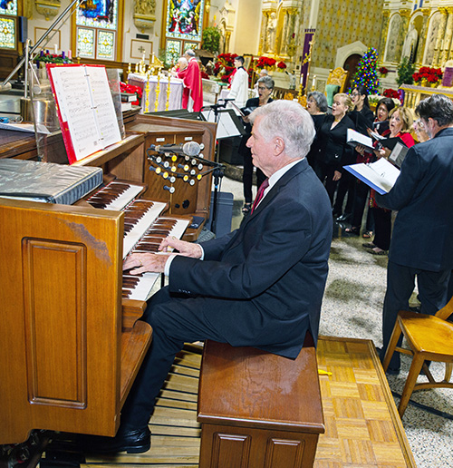 William VanderWyden III plays the organ as members of the St. John Neuman Music Ministry sing in the background. 
Archbishop Thomas Wenski celebrated annual Red Mass at Gesu Church of Miami on Dec. 11, 2024.