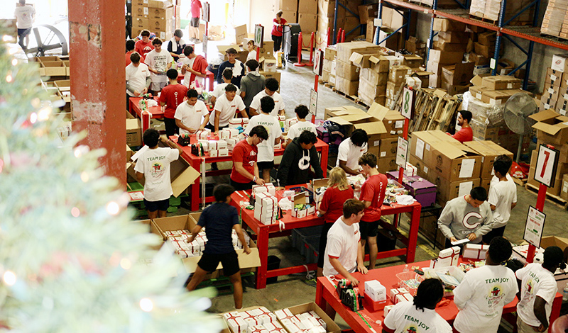 Christopher Columbus High students screen and prepare “Boxes of Joy” with Christmas gifts for underprivileged children at Box of Joy National Screening Center in Doral Dec. 12, 2024.