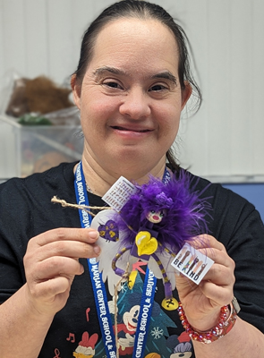 Bernadette Guilarte poses with the sign language angel ornament she designed at the Marian Center this holiday season.