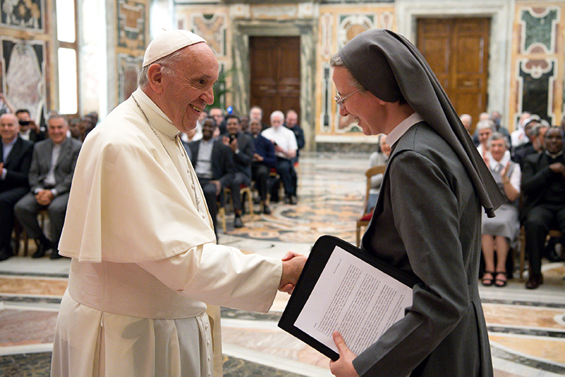 Pope Francis greets Consolata Sister Simona Brambilla, superior general of the Consolata Missionary Sisters, during a June 5 audience with the men's and women's branches of the religious missionary congregation.