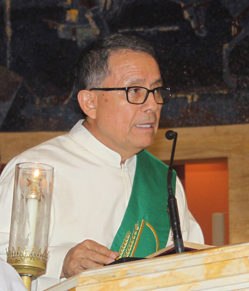 In this February 2018 file photo, Deacon Jose Chirinos, spiritual director of the Catholic Charismatic Renewal in the Archdiocese of Miami, reads the Gospel at the closing Mass of the movement's 50th anniversary celebrations around the world.