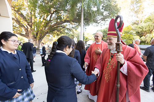 Archbishop Thomas Wenski greets students at St. Mary Star of the Sea Basilica School in Kew West, Dec. 13, 2024, after presiding at the dedication Mass of the new Basilica High School building which had been closed for decades.