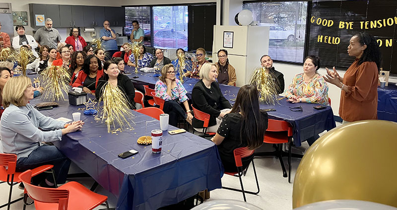 Catholic Hospice's new executive director, Diana Smith-Lopez, right, thanks Dian Backoff, seated front left, for six years of visionary leadership of Catholic Hospice at Backoff's retirement breakfast Dec. 20, 2024 at the Miami Lakes office.