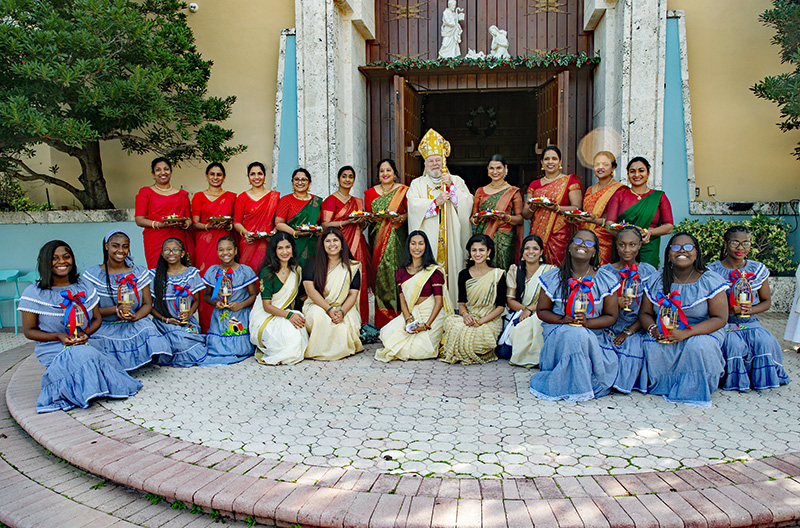 Members of the Indian-American and Haitian-American Apostolates pose for a photo with Archbishop Thomas Wenski after the annual Migration Mass, celebrated by him Jan. 5, 2025, feast of the Epiphany, at St. Mary Cathedral of Miami.