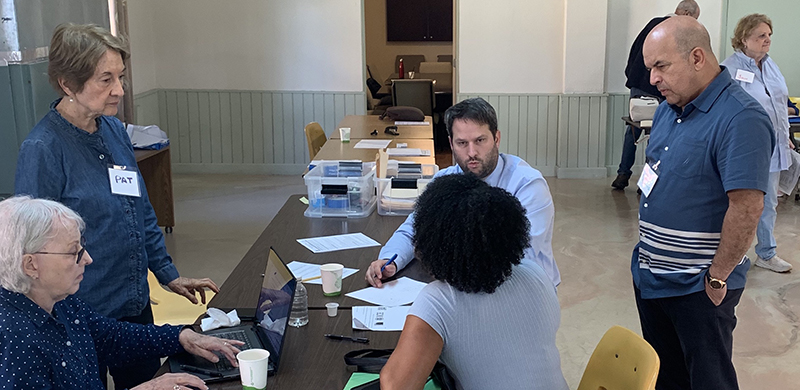 Members of the Teresian Association partner with Catholic Legal Services in the Immigrant Outreach Project at Corpus Christi Parish in Miami. From left, seated, Teresa Casal, Patricia Stockton, attorney Joe Cano and Orlando Marquez of Catholic Legal Services listen to an immigrant's case.