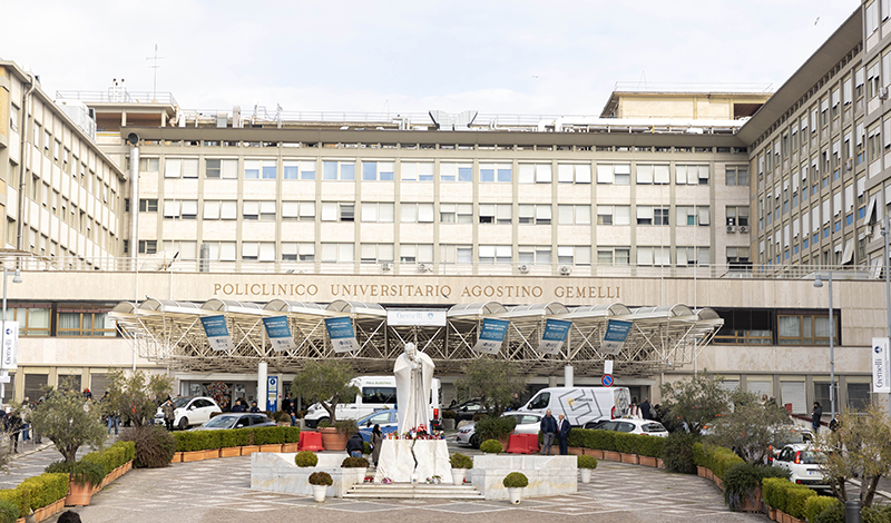 A statue of St. John Paul II stands outside the main entrance of Rome's Gemelli hospital Feb. 18, 2025. Pope Francis has been an inpatient at the hospital since Feb. 14.