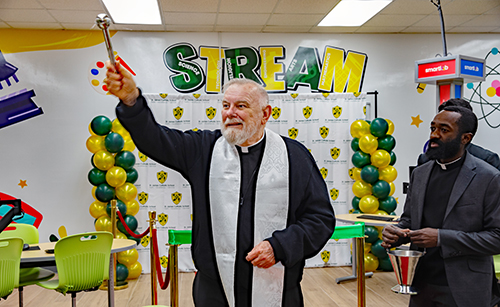 Archbishop Thomas Wenski blesses the new SmartLab at St. James School Jan. 22, 2025. With him is Father George Fenly Saint-Jean, the pastor of the church in North Miami.