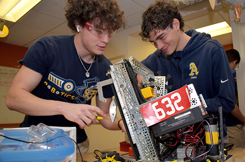 From left, St. Thomas Aquinas High School students Miles Monahan and Santiago Vasquez work in the robotics lab at the school in Fort Lauderdale during the Sister John Norton STEAMS Competition on Jan. 25, 2025.