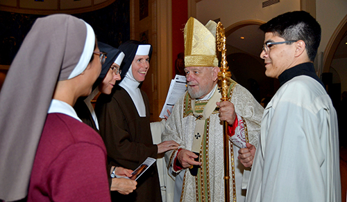 After the annual Mass for the World Day of Prayer for Consecrated Life celebrated by Archbishop Thomas Wenski Feb. 2, 2025, at St. Mary Cathedral, the Archbishop speaks with a Sister from the Servants of the Pierced Hearts of Jesus and Mary (left) and two Sisters of the Carmelite Sisters of the Most Sacred Heart of Los Angeles. Father Agustin Estrada, priest secretary of the archbishop accompanied them.