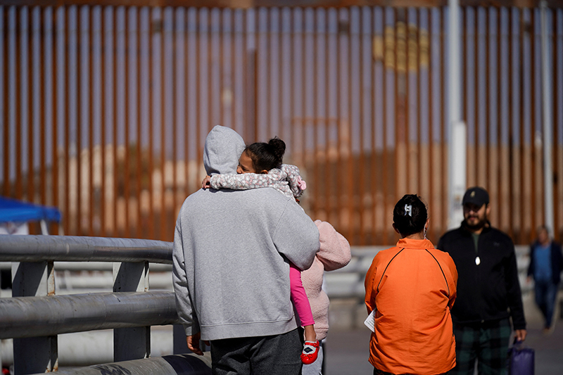 Cuban migrant Marielis Arosh and her family walk with other migrants after their CBP One app asylum appointment was cancelled on the day of U.S. President Donald Trump's inauguration, near the border fence in Mexicali, Mexico, Jan. 20, 2025. (OSV News photo/Victor Medina, Reuters)