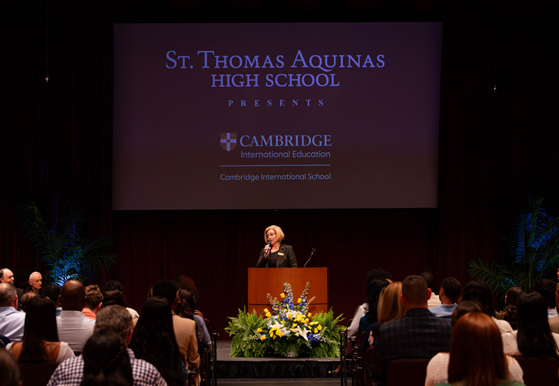 Denisa Aloma, principal of St. Thomas Aquinas High, speaks to students and parents about the school's partnership with Cambridge Education during an event on Feb. 12, 2025 at the Bienes Center for the Arts in Fort Lauderdale.