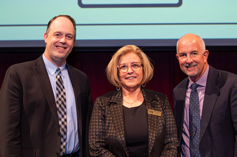 St. Thomas Aquinas High has become the first Catholic school in the nation to partner with Cambridge Education. Jim Rigg (left), superintendent of Catholic schools in the Archdiocese of Miami, Denise Aloma, principal of STA, and Donald Meyers, regional manager for school deployment at Cambridge were present at the announcement event on Feb. 12, 2025 at the Bienes Center for the Arts in Fort Lauderdale