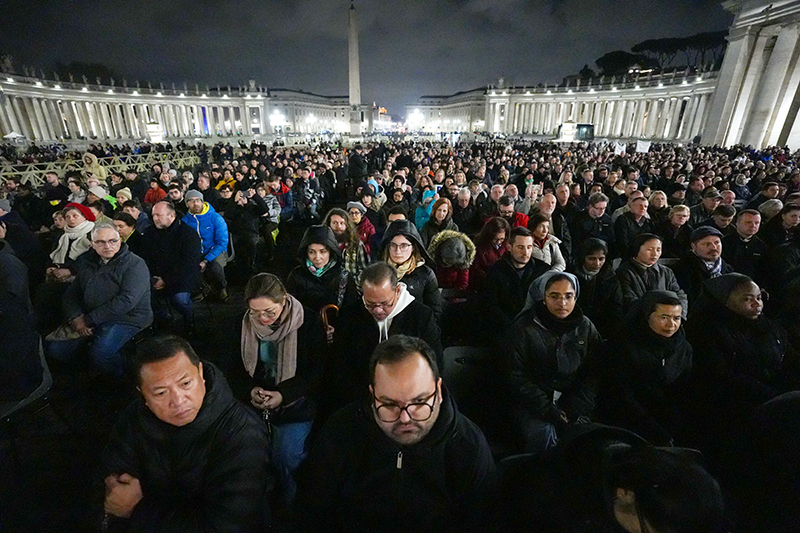 People join Cardinal Luis Antonio Tagle, pro-prefect of the Dicastery for Evangelization, in praying the rosary for Pope Francis in St. Peter's Square at the Vatican Feb. 24, 2025. Other cardinals living in Rome, leaders of the Roman Curia and the faithful joined him for the nighttime prayer.