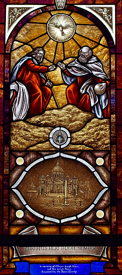 The Holy Trinity of Father, Son and Holy Spirit oversees the Church in this window at St. Matthew Church in Hallandale.