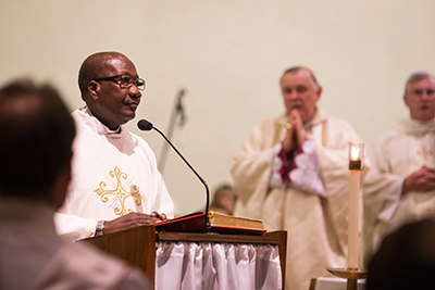 In this Oct. 22, 2014, file photo, Father Kidney M. St. Jean, pastor of Our Lady Queen of Heaven Parish in Fort Lauderdale, reads the Gospel during the parish's 40th anniversary Mass and celebration.