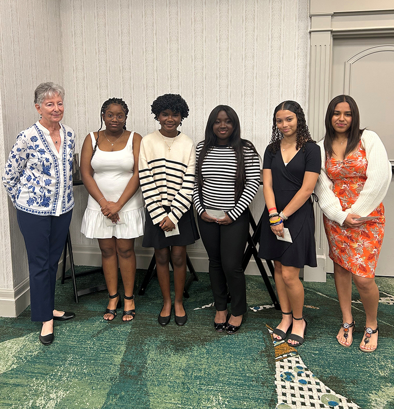 Left to right, MACCW scholarship committee chair Mary Weber stands with 2024 scholarship winners Moriah Francois, Amelia Pryce, Ashley Bel, Jasmine Viola and Ana De Leon at the 26th Annual Fundraiser for the MACCW Scholarship Fund on Feb. 22 at the  Embassy Suites Hotel Fort Lauderdale.