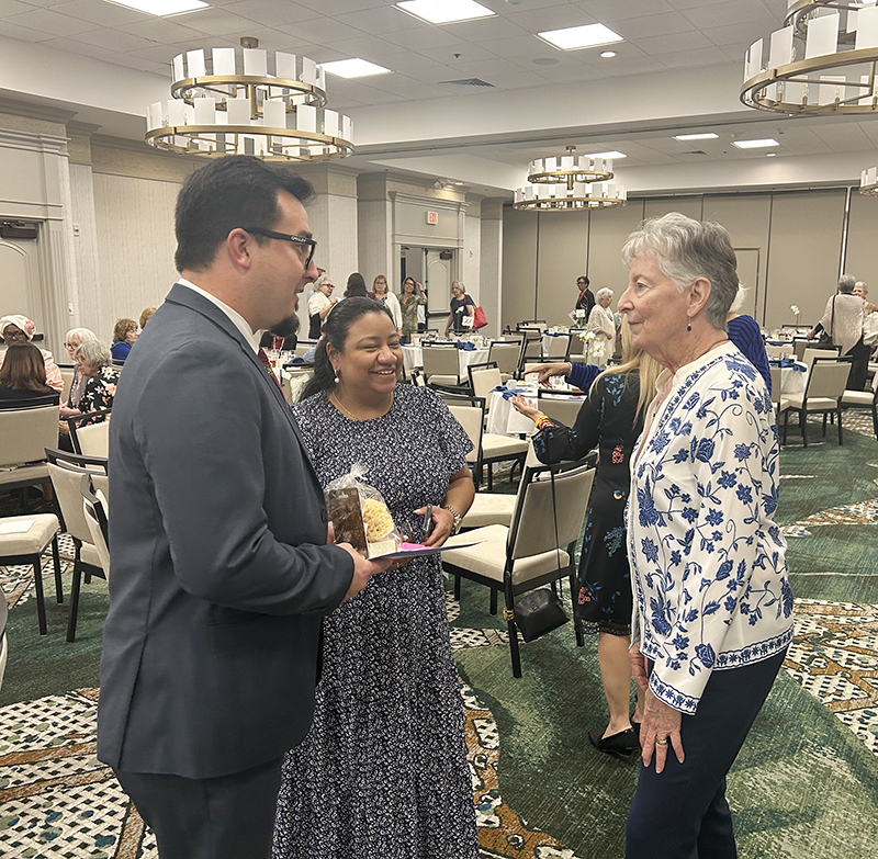 Left to right, Oscar Cedeño, principal of Cardinal Gibbons High School in Fort Lauderdale and past MACCW honoree, and his wife Melissa Cedeño, a teacher at Belen Jesuit Preparatory School, speak with scholarship committee chair Mary Weber at the MACCW fundraiser luncheon held on Feb. 22, 2025 at the Embassy Suites Hotel Fort Lauderdale.