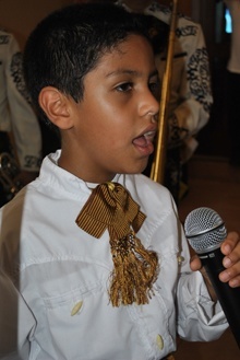 David Mora Arriaga, 7, of the Mora Arriage mariachi troupe, sings for St. John Bosco as the relics arrive at the church.