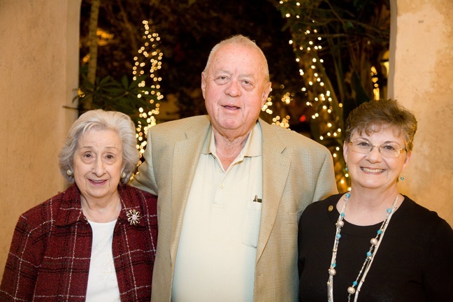 Serra Club Broward County President Georgette Meikle, right, poses with 50-year member Thomas Metzger and his wife Betty, after recognizing him at the club's holiday dinner Dec. 6 in Pompano Beach.