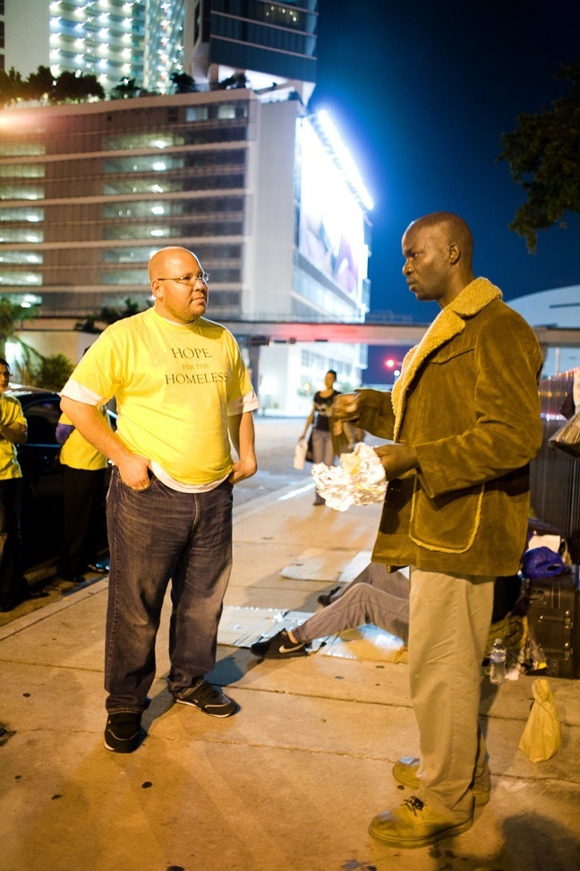 Mario Lezma ministers to a homeless man.